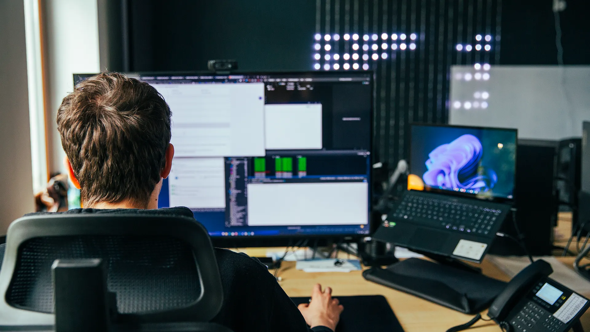 Ein Entwickler bei Trendsetzer programmiert konzentriert an mehreren Monitoren – professionelle Softwareentwicklung und Webdesign in der Agentur.