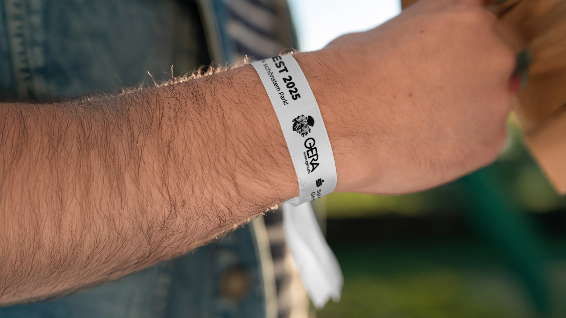 Einlassband mit Logo und Schriftzug der Stadt Gera als modernes Veranstaltungsdetail.
